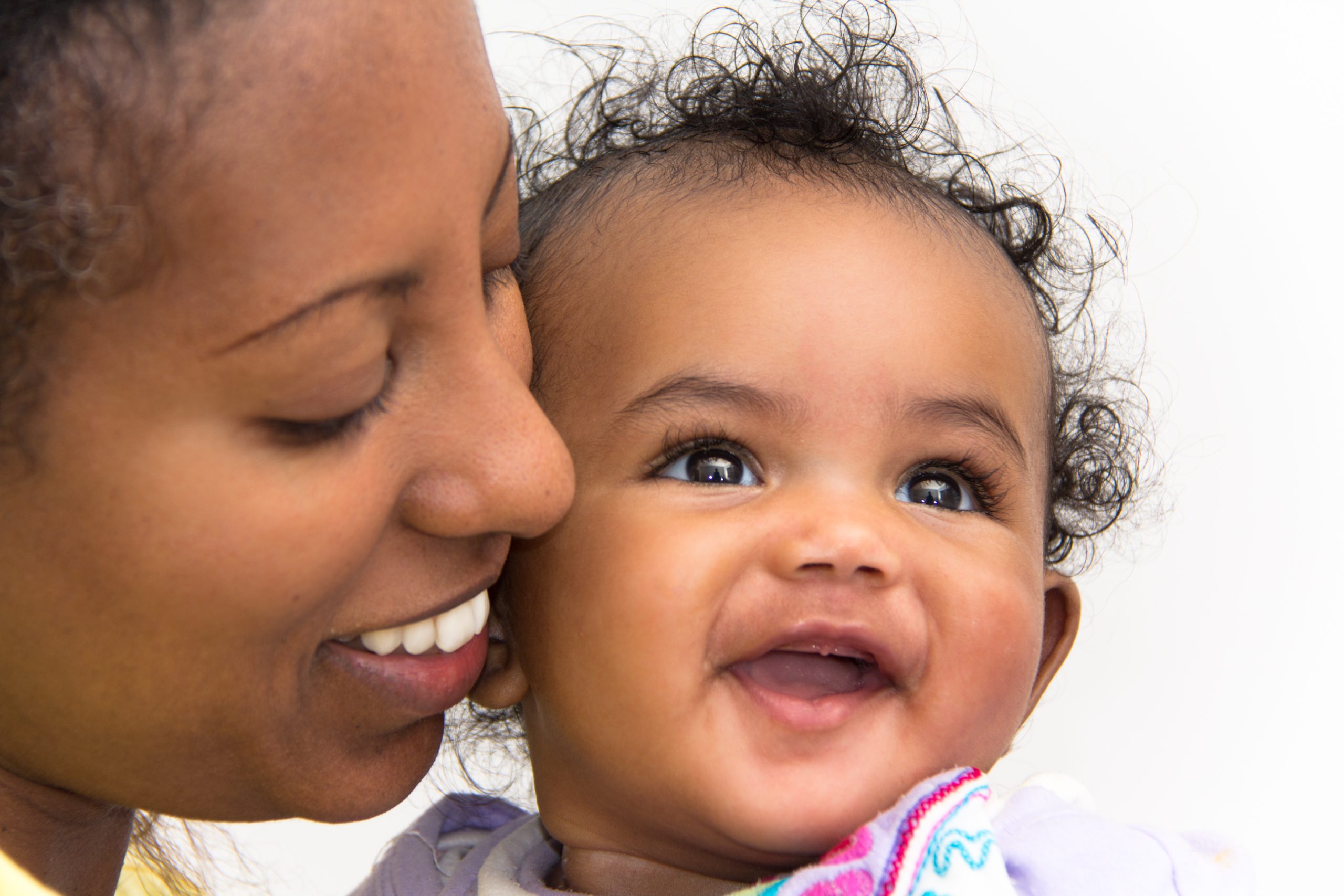 mother looking lovingly at her smiling infant