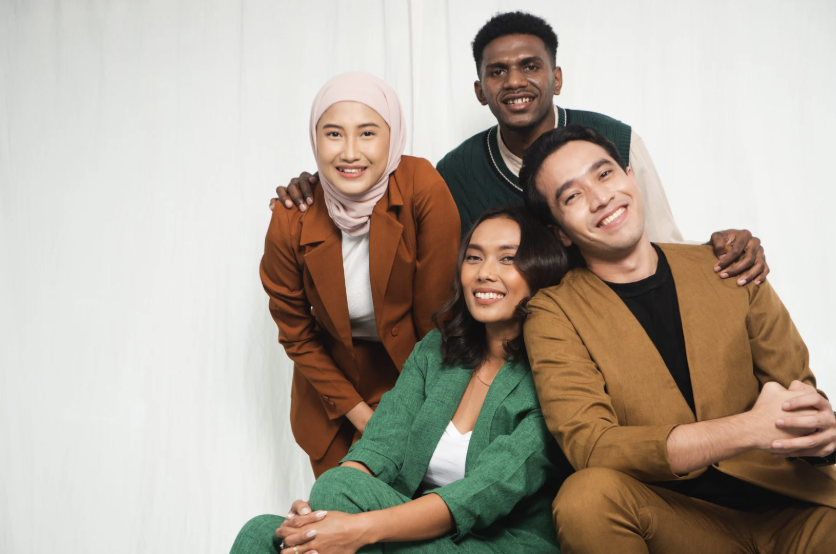 four people smiling together