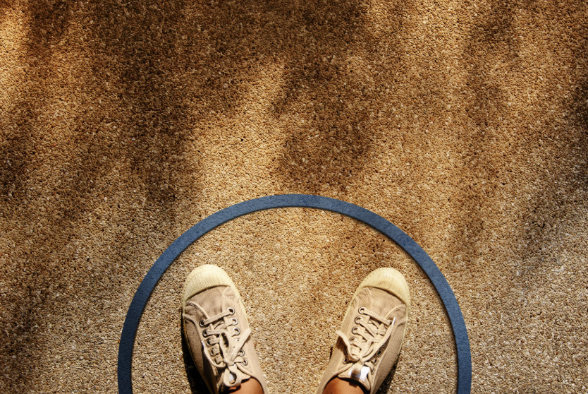 two feet standing within the boundary of a circle