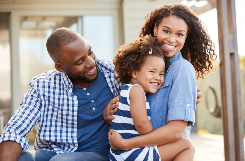 father, mother, daughter hugging and smiling