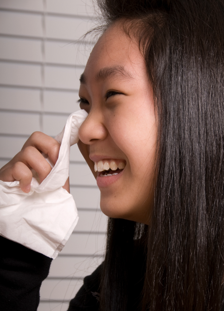 woman crying happy tears holding tissue